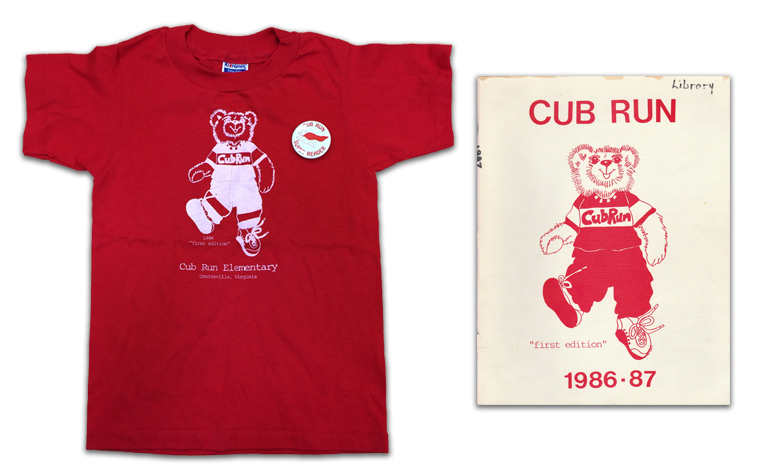 Photograph of Cub Run Elementary's first edition t-shirt, button, and yearbook.